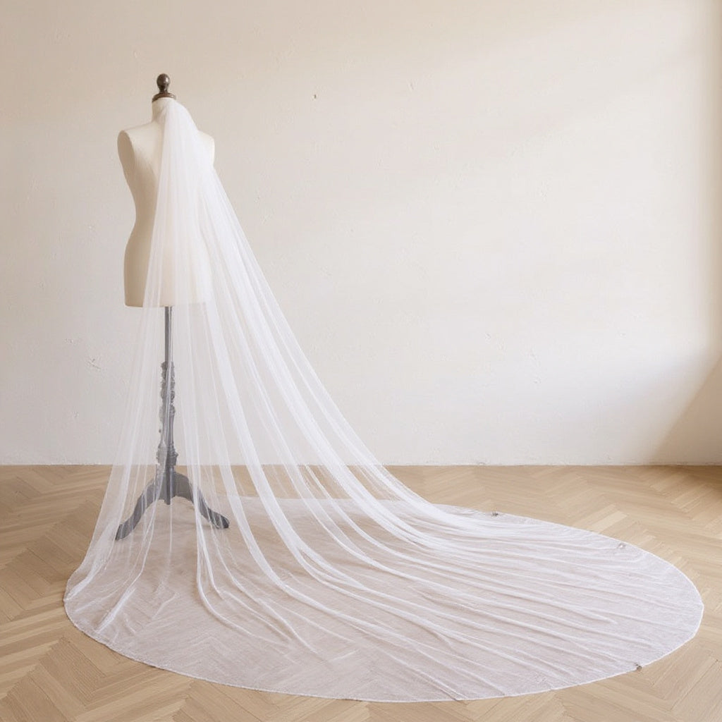 The Margaux veil on a dress form, soft daylight