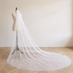 The Margaux veil on a dress form, soft daylight
