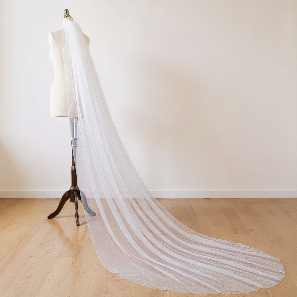 The Margaux veil on a dress form, soft daylight