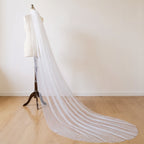 The Margaux veil on a dress form, soft daylight