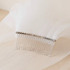 The Margaux veil on a dress form, soft daylight