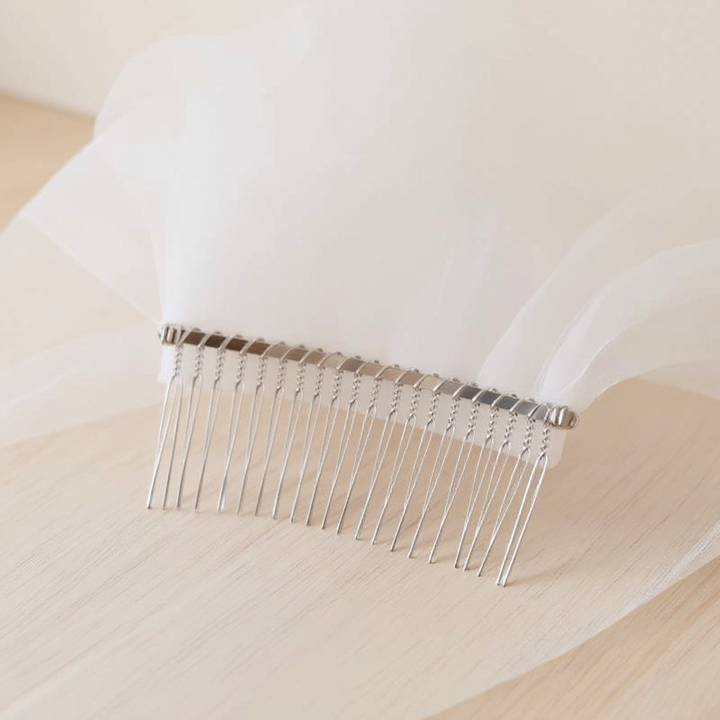 The Margaux veil on a dress form, soft daylight